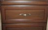 Close-up view of drawers with custom handles. Chocolate Pear color - Premier Finish.