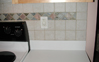 Close-up of tile back-splash showing accented center trim